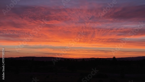 Vibrant orange twilight sky, evening atmosphere, seasonal change