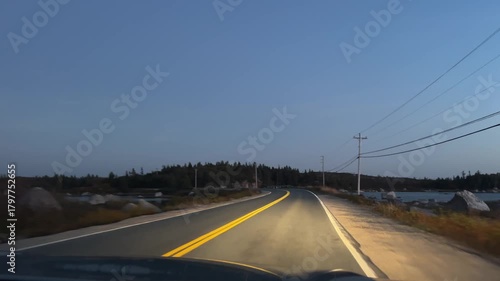 Cinematic POV Night Drive Through Nova Scotia Countryside Canada. Peaceful Night Scene From Inside A Moving Car, Passing Through Forest Roads Lit By Headlights And The Full Moon.Nova Scotia Peggys