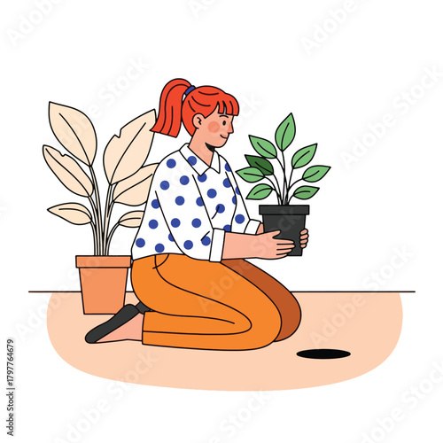 Woman kneeling and holding a potted plant