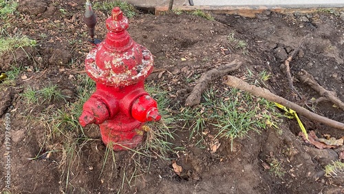 an old red fire hydrant been dug up in a construction site