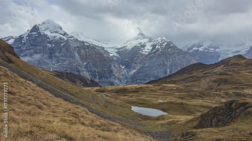 Time lapse, view on a lake surrounded by mountains. Calm and peaceful lake high in the mountains. Grindelwald, canton of Berne, Switzerland