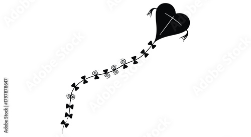 Whimsical black heart-shaped kite with a long, patterned tail soaring against a white background