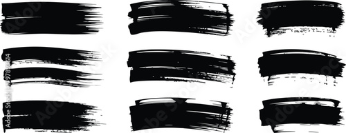 Abstract black brush strokes on a white background, a collection of textured paint marks
