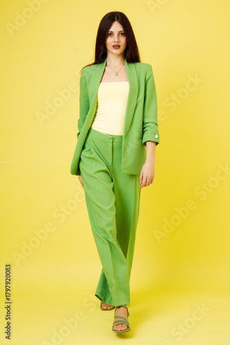 Fashion portrait of beautiful model in green suit