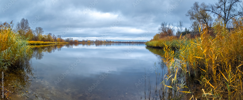 Fototapeta premium Beautiful autumn landscape with a lake and blue water. Retro-style landscape. Unusual colors. Sunset on the lake. 4K 60fps. Cinematic footage.