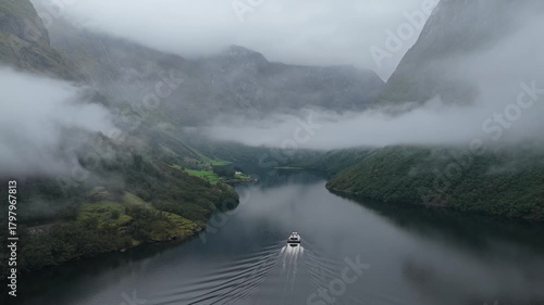 Aerial view of white tour boat crossing calm Sognefjord waters, Norway