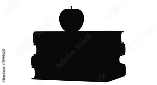 A silhouetted image of an apple resting on top of stacked books