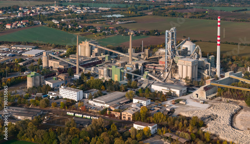 Aerial view of large cement factory complex with industrial smokestacks and quarry, Lafarge cement plant, Czech Republic