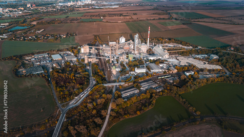 Aerial view of large cement factory complex with industrial smokestacks and quarry, Lafarge cement plant, Czech Republic