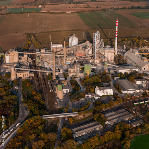 Aerial view of large cement factory complex with industrial smokestacks and quarry, Lafarge cement plant, Czech Republic