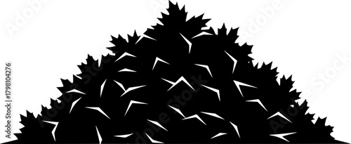 The silhouette of a large pile of leaves creates an iconic on white
