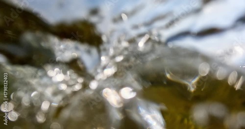 Closeup view of waves crashing on rocky shore in sunny summer weather with clouds in the sky, Pirttisaari nature reserve, Porvoo, Finland. 