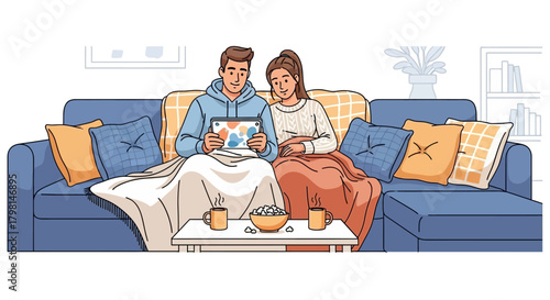 Young couple sitting on a sofa looking at a photo album together.