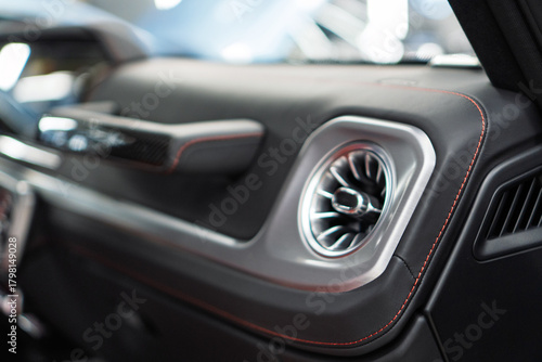 Automotive climate control. Airflow inside the car. Air conditioner flow inside the car, plastic grid panel. Vehicle air conditioning closeup view. Detail interior of modern car. Air ducts. Dashboard.