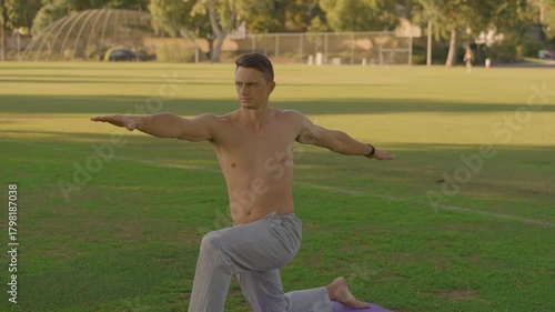 Young Fit Man Doing Outdoor Yoga and Core Workout on a Mat in the Park