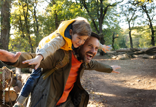 Dad and son enjoy a fun day outdoors in the forest