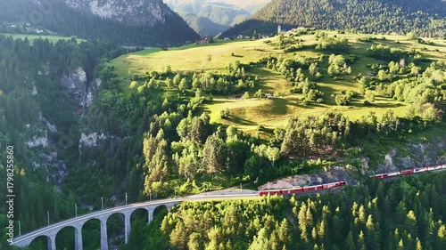 red swiss train on Landwasser viaduct bridge in Swiss Alps. Zermatt to St. Moritz.  scenic railway. Switzerland summer tourism.