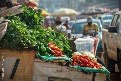 fresh vegetables at the market, Colorful photo of an African market in Cameroon, showcasing fresh vegetables cassava leaves, peppers, carrots and chilies.