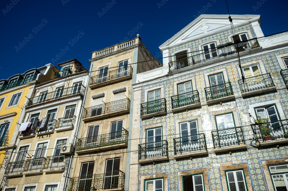 Obraz premium View of a typical facades or a row of historic tiled buildings in Lisbon, Portugal