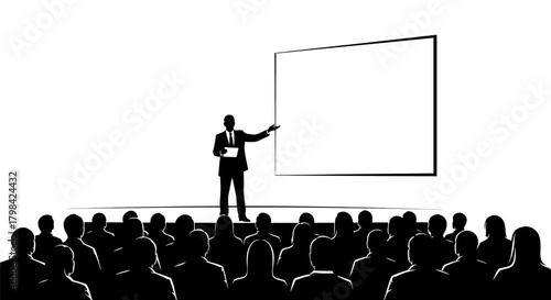 A speaker presents to a silhouetted audience in front of a blank projection screen