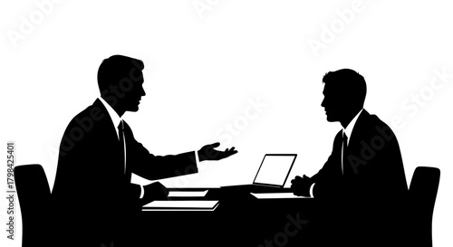 Two businessmen in silhouette have a discussion around a desk with a laptop