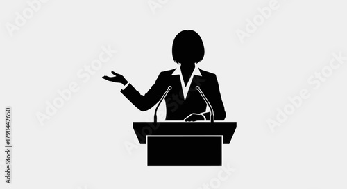Black silhouette of a person at a podium speaking into microphones