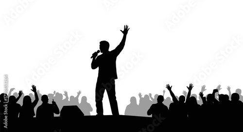 Silhouette of a speaker on stage with a crowd raising hands