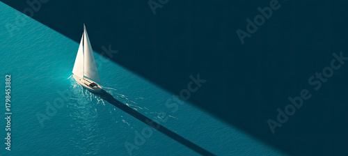 Sailboat gliding on teal ocean water