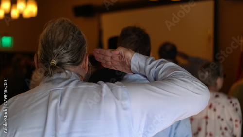 Vietnam veteran salutes the American flag at a reunion dinner