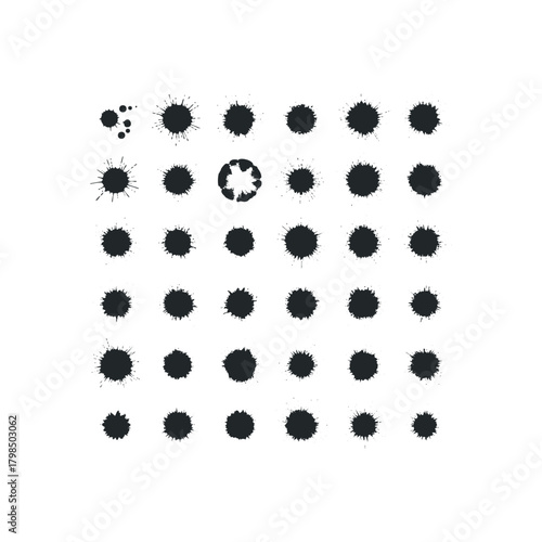 Black ink splatters on white surface