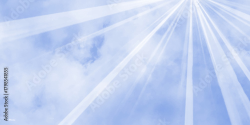 Bright rays of light in blue sky. Winter sun in the blue sky. Blue sky with picturesque fluffy clouds background. Blue sky with fluffy white clouds. Beautiful nature background.