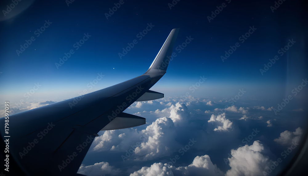 Fototapeta premium Airplane Wing Over Clouds High Altitude Flight Experience