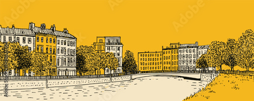A yellow and orange cityscape with a river running through it. The buildings are old and the street is lined with trees
