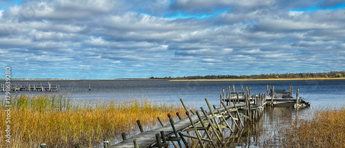 Two rickety old wooden boat docks on the Rainy River in northern Minnesota, with Ontario, Canada, across the water.