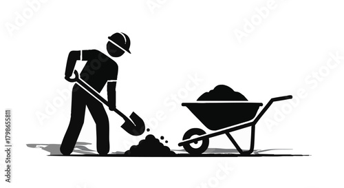 A construction worker uses a shovel to move dirt near a wheelbarrow, illustrating manual labor and construction tasks in progress.