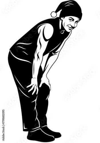 Playful man in a Santa hat bending down with a mischievous grin.