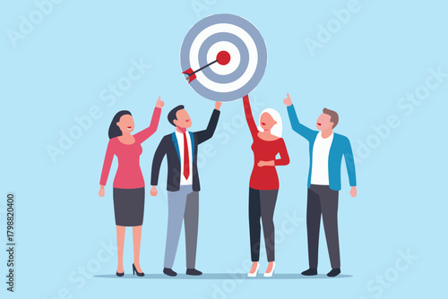 Diverse business team celebrating success by holding up a target with an arrow hitting the bullseye