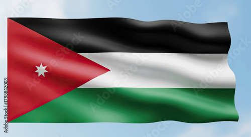 The national flag of Jordan is waving in the wind against a clear blue sky with white clouds.