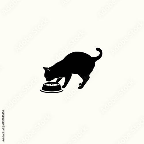 A black silhouette of a cat eating from a food bowl on a plain background.
