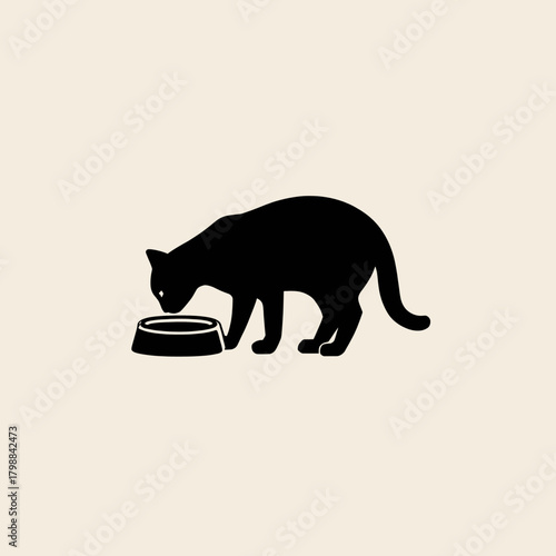 A black silhouette of a domestic cat is depicted bending down to eat or drink from a small, round bowl on a plain, light background.