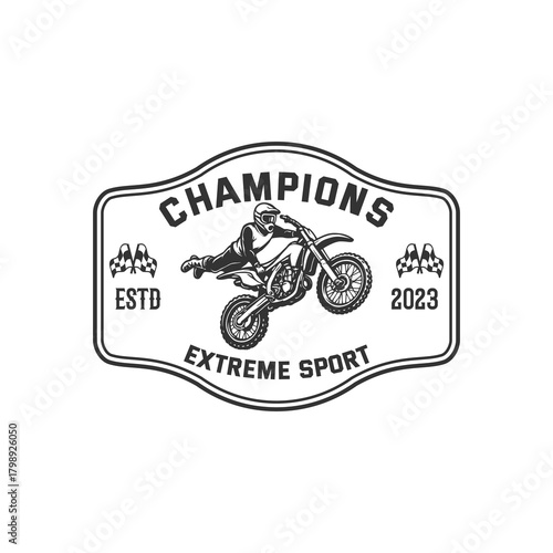 This logo features a motocross rider performing an extreme stunt, capturing the spirit of speed, power, and adrenaline. The dynamic illustration, combined with bold wing-like stripes, creates a strong