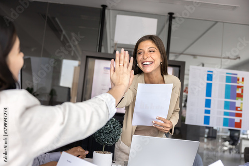 Positive business leader giving high five hand to female colleague