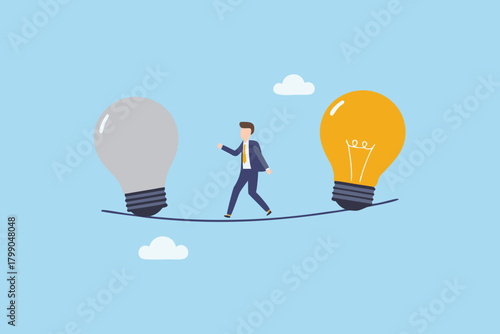 Businessman walking on a tightrope between a grey and a yellow light bulb representing ideas