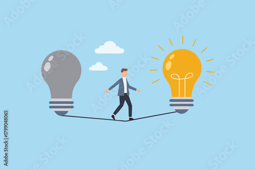 Businessman walking a tightrope between a dull and a bright idea lightbulb symbolizing innovation and creativity