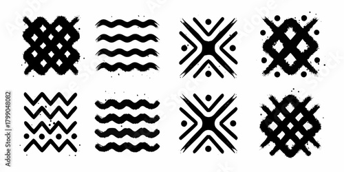 Collection of abstract black brush stroke patterns and tribal symbols on a white background