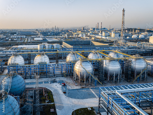 Spherical pressurized gas storage tanks at a modern petrochemical refinery industrial complex.