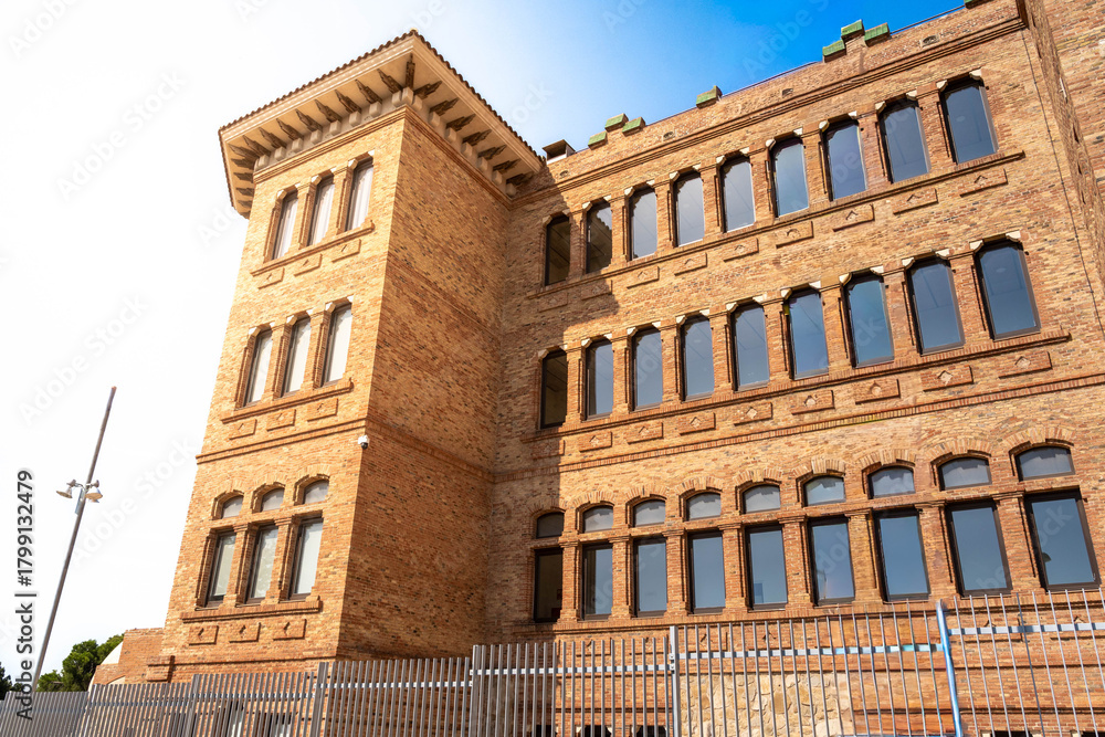 Fototapeta premium Centre de Formació Marie Curie, a historical brick building (Pavelló B of the former Hospital de l'Esperit Sant) with traditional Catalan architecture, Santa Coloma de Gramanet, Spain