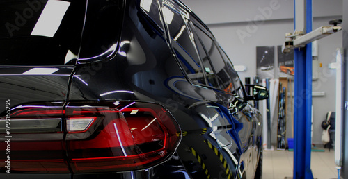 A luxury SUV is being prepared for service inspection and diagnostics at a car workshop
