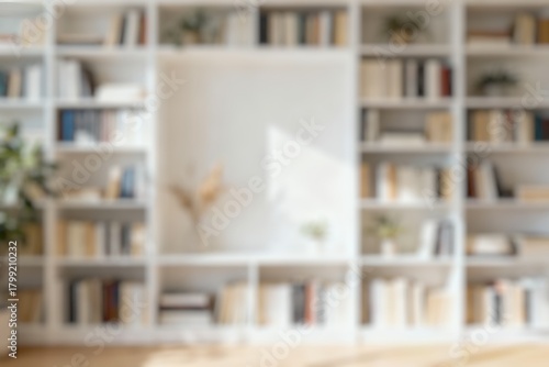 Defocused Background of Cozy Home Library with Green Plants and Colorful Books on Light Wooden Shelves. Blurred Background Photo.
