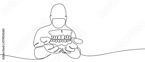 The doctor is holding a denture in his hand, in one continuous line. Dynamic single line draw design vector illustration Editable stroke.